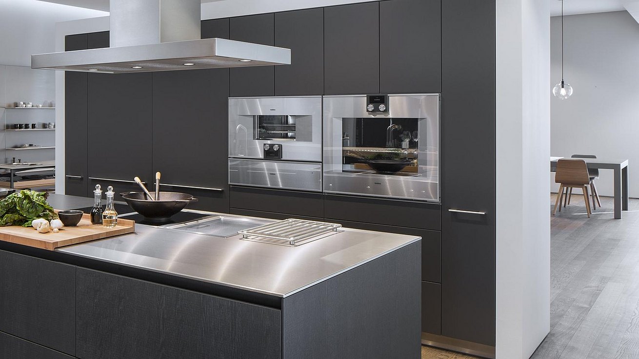 Another view of b3 kitchen display in dark wood and stainless steel.